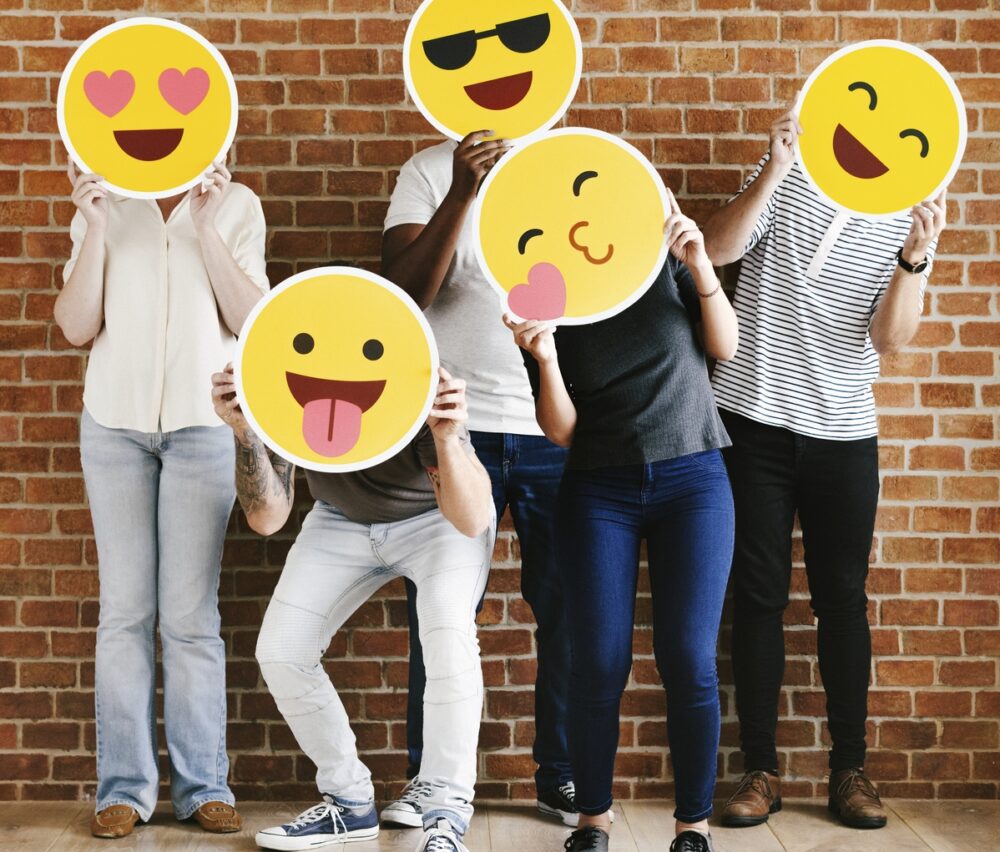 People holding positive emoticons